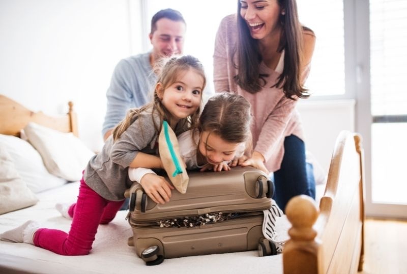 Family packing a suitcase.