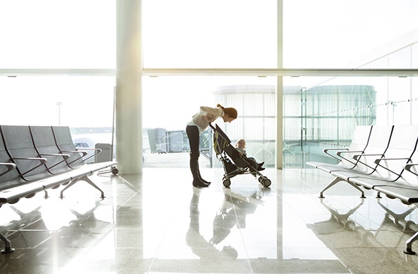 mum pushing a pram in the airport