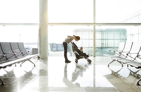 mum pushing a pram in the airport 