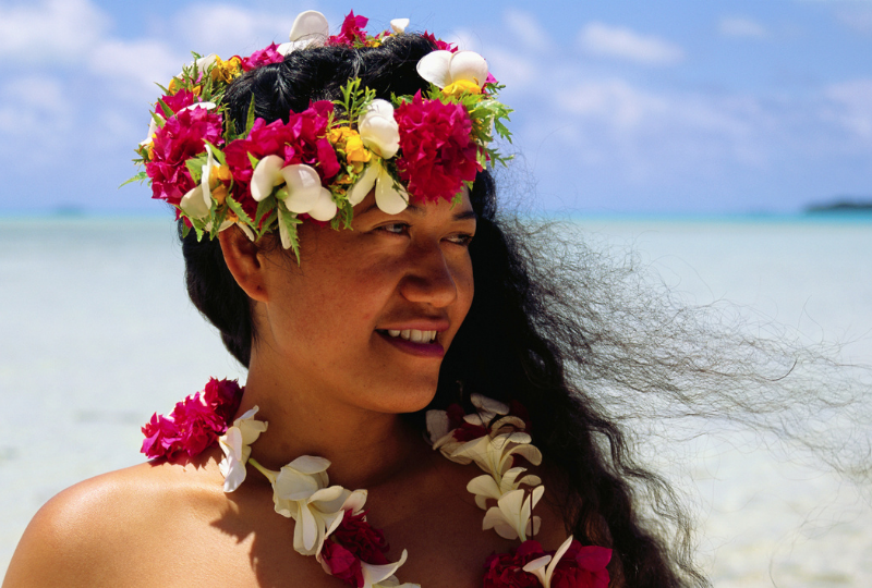 Cook Islands Woman Wearing traditional flower wreath on head smiling looking to the left