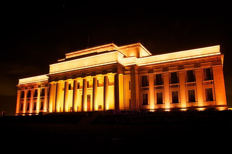 Auckland museum at night lit up by lights 
