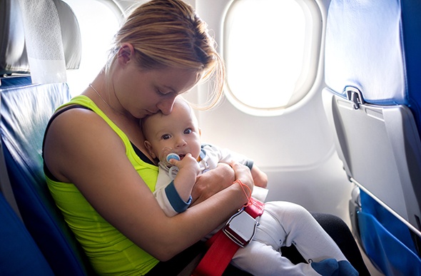 mum holding her baby on a plane 