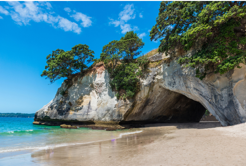 Naturally formed rock archway, cathedral cove on the water
