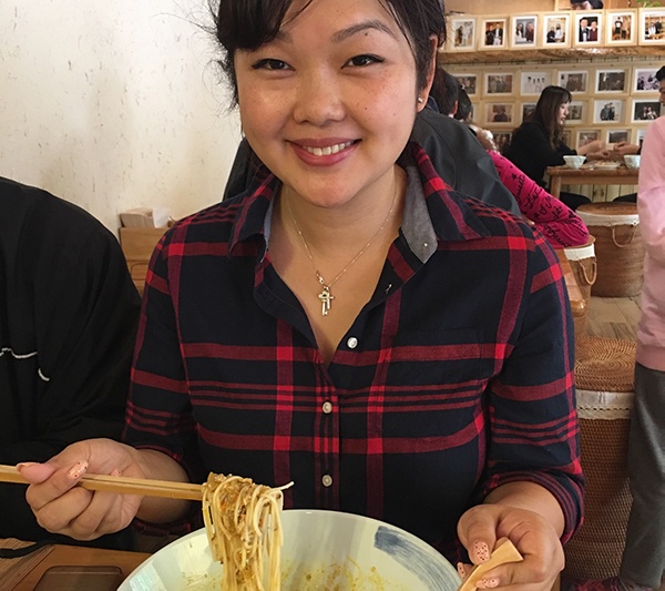 Woman with hairy crab roe noodles
