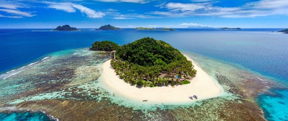 tiny fijian island surrounded by coral reef