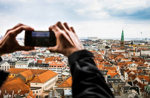  Tourist taking a photo of the town of Copenhagen 