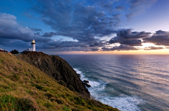 The Byron Bay lighthouse looks over the ocean sunset