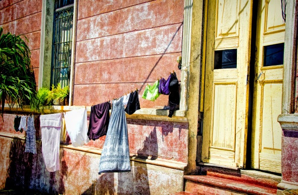  Washing hanging on a clothesline in front of a red brick wall