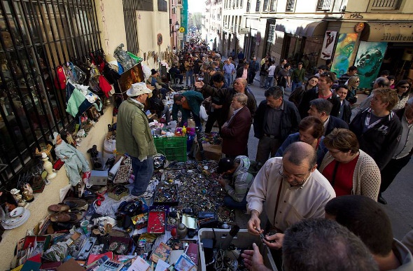  People look through treasures at El Rastro Flea Market in Madrid, Spain
