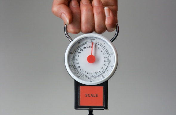 A person holding a scale
