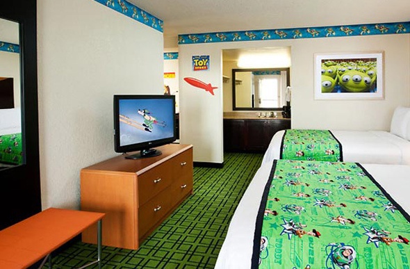  Toy Story-themed hotel room with two beds, a television and wall decorations