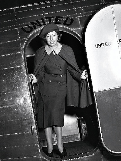 United Airlines' flight attendant in their old uniform stood at the aircraft door
