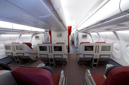 A full view of Garuda Indonesia's business class cabin featuring seats with LED monitors