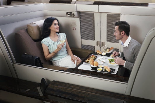  A couple sharing a fancy meal together while flying fist class with Garuda Indonesia