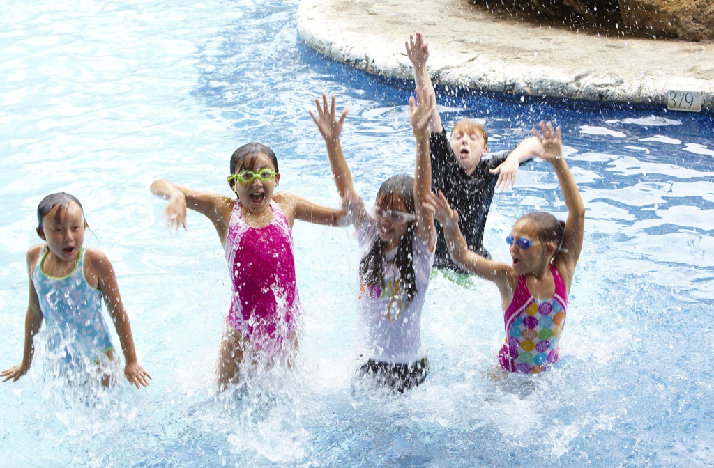 Children happily playing in the pool