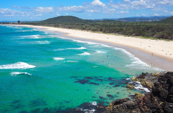 The wide sweep of sand and blue-green water of Cabarita Beach in New South Wales.