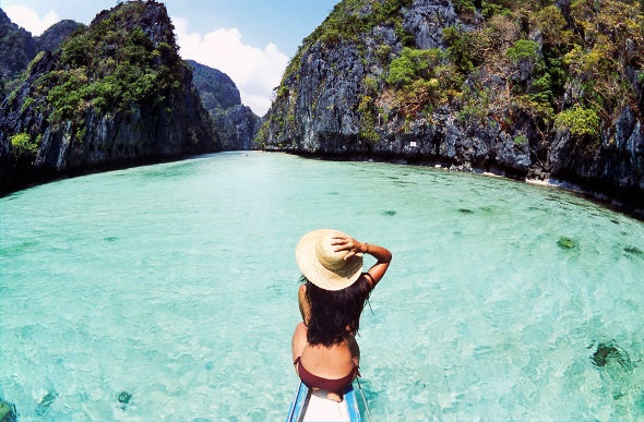  Woman swimming in the clear blue water at the Philippines 