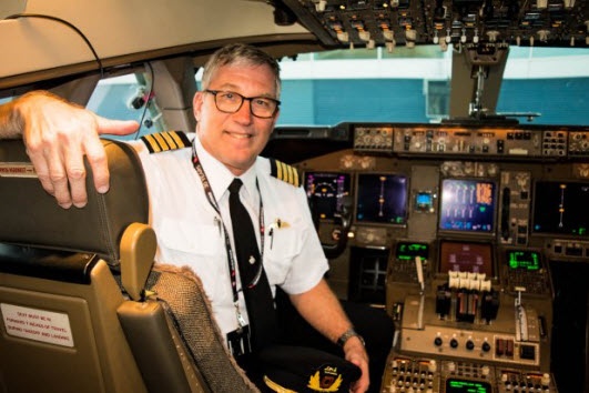  Qantas pilot posing in the cockpit 