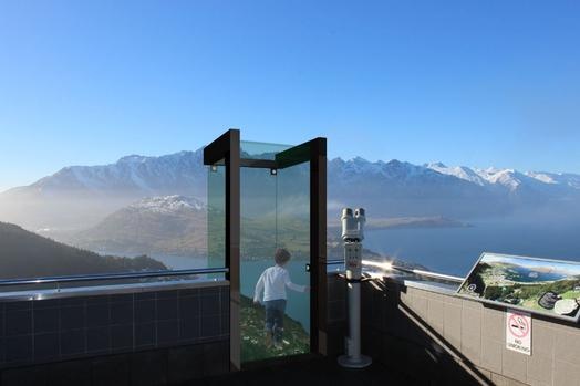 Little boy enjoying the view of the mountains in a viewing cube