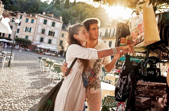 Young couple on vacation in Portofino shopping for souvenirs.
