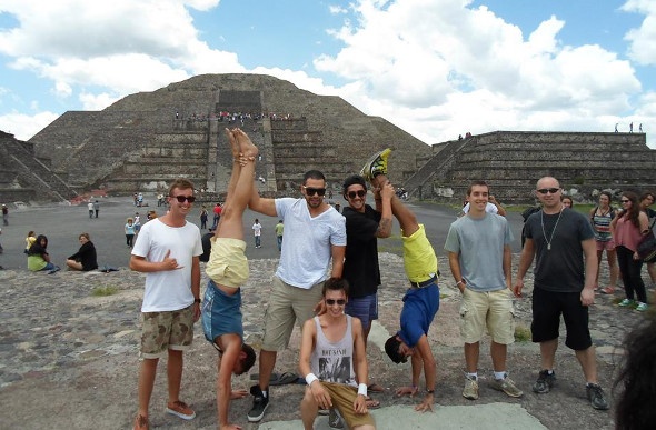 Group doing creative poses with the Teotihuacán Pyramids behind them