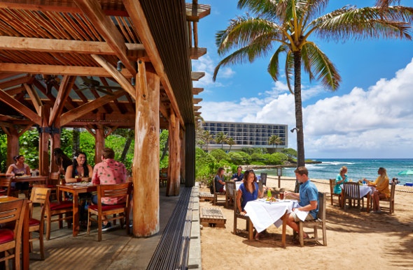 At Ola restaurant at Turtle Bay Resort, people can dine inside or outside on the sand