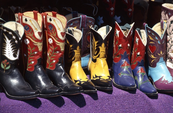 A row of colourful cowboy boots at a California flea market