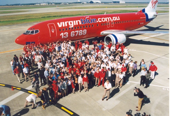  Group of people taking selfie with the Virgin airways aircraft as the background 
