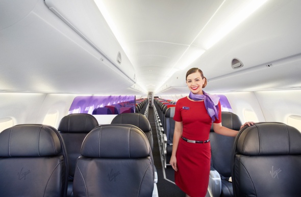  Virgin Australia flight attendant standing in the aisle  