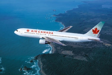 Air Canada plane flying over the ocean 