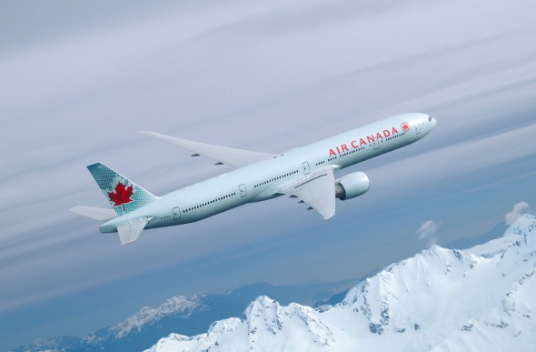  Air Canada plane flying over snow capped mountains 