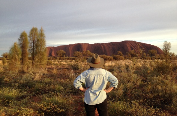  Person admiring Uluru on an overcast day 