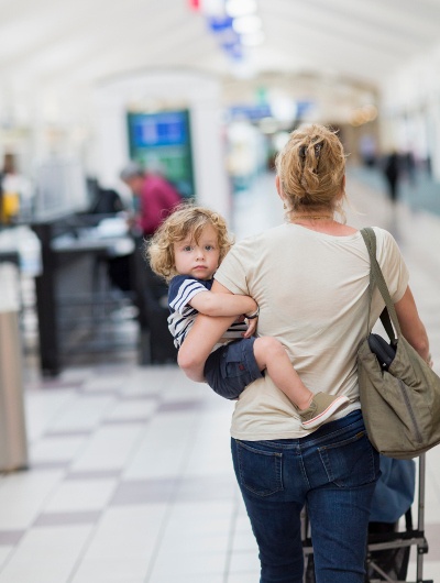  Lady carrying her child in the Airport