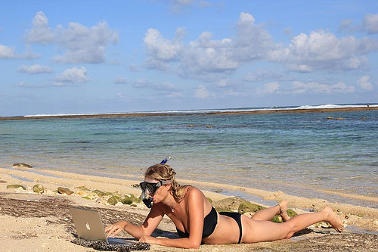  Woman relaxing on a Bali beach in her bikini 