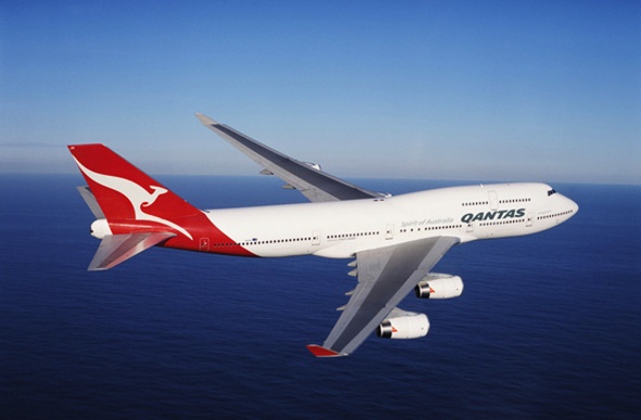 Qantas' airplane soaring across the sea