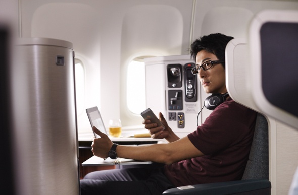  Man sitting in Cathay Pacific business class 