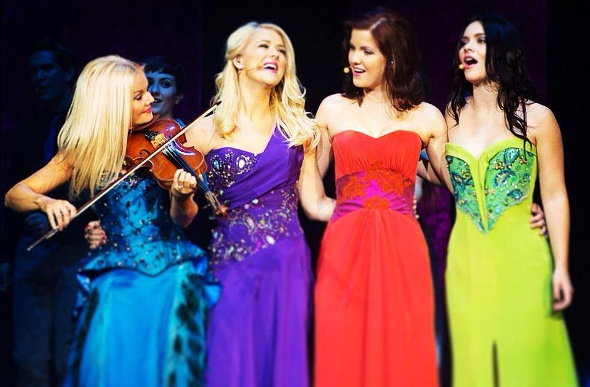 Celtic women performing in colourful dresses