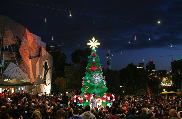 Huge Christmas tree surrounded by a crowd of people