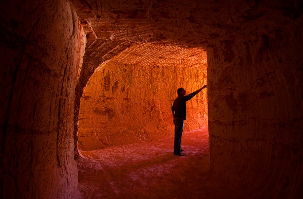 A man stands in an opal-mining tunnel in Coober Pedy.