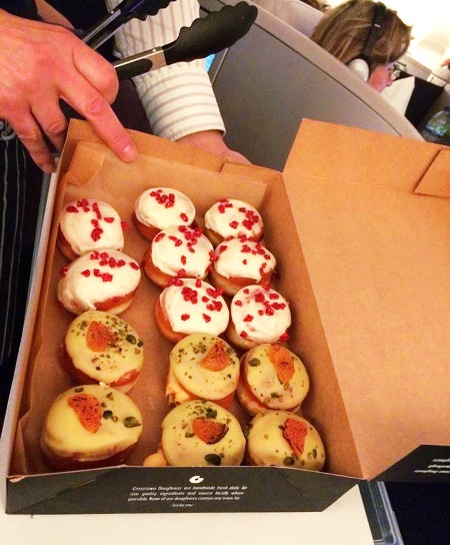  staff filling up a box with 15 pieces of  different flavoured doughnuts