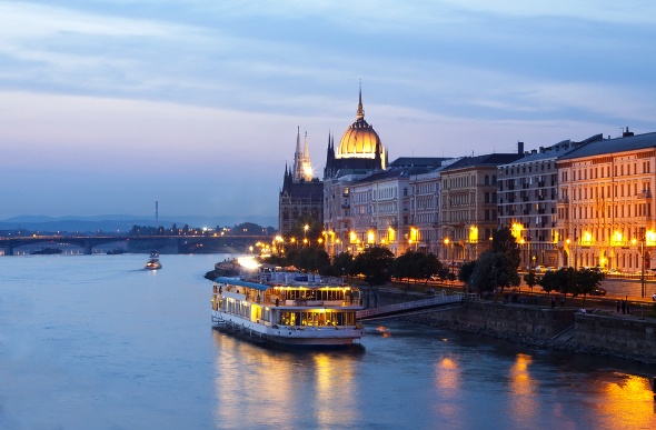  River cruise boat going past the Hungarian Parliament Building on the River Danube