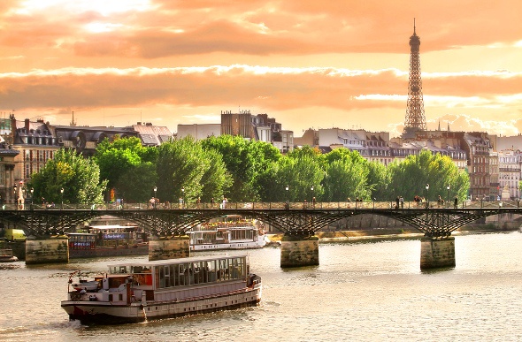  river cruise boat going down the Sienne in Paris with Eiffel Tower in background