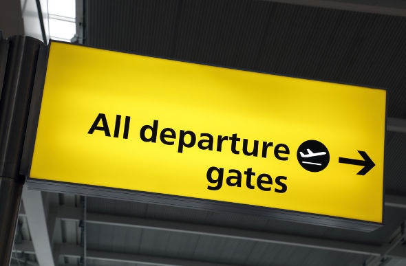 Bright yellow departure gate airport sign