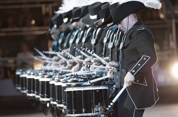 Marching band wearing matching black uniforms