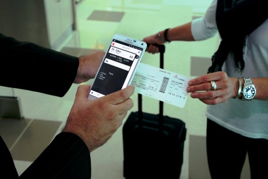 Digitally scanning plane ticket before boarding the plane