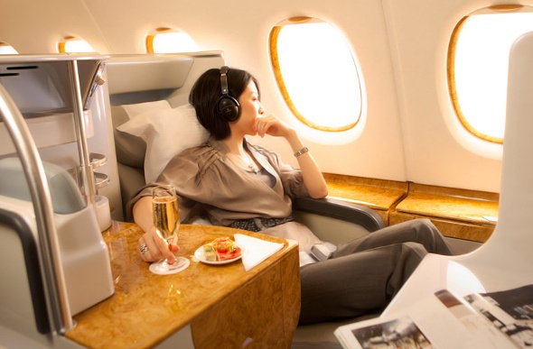 Woman relaxing and looking out the window in business class 