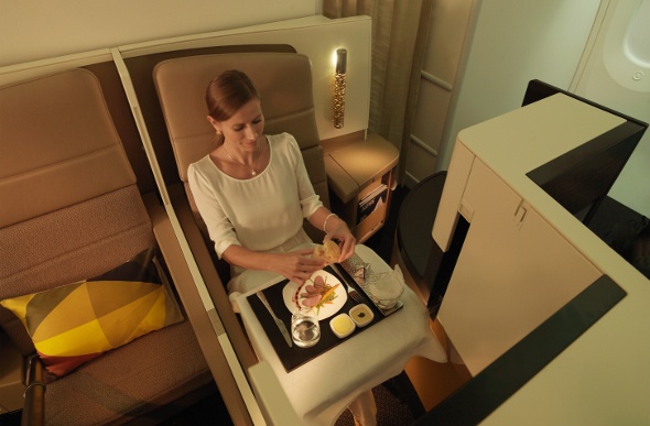  Woman eating dinner in business class 