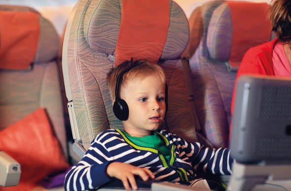 a little boy sitting in an airplane seat