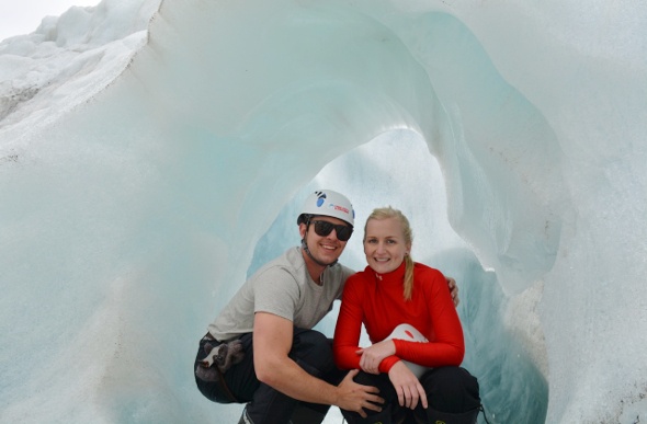  Happy couple has their photo taken inside an ice tunnel