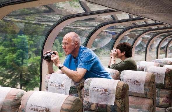 Tourists taking photos of the wonderful nature view outside the glass windows of the Goldleaf train